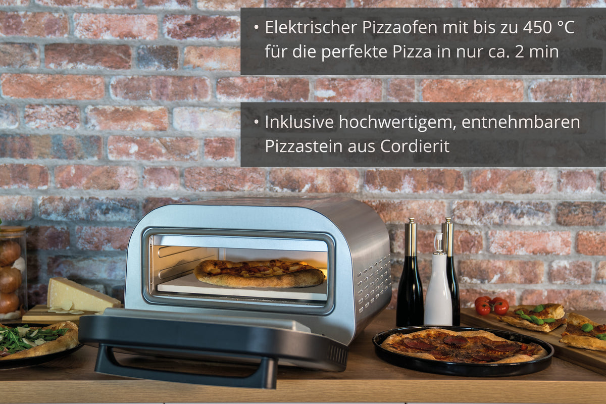 Der Unold Pizzaofen LUIGI, ein moderner elektrischer Pizzaofen mit Digitalanzeige und herausnehmbarem Cordieritstein, steht mit frischen Pizzen, Zutaten und Gewürzen auf einer Holzarbeitsplatte vor einer Backsteinwand mit deutscher Textauflage.