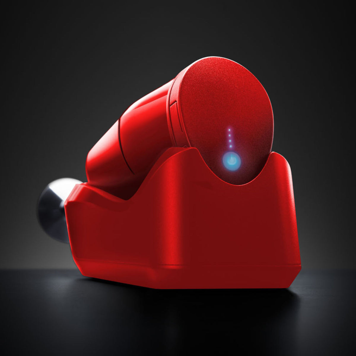 Der ESGE-Zauberstab Cordless PLUS Rot, ein elegantes, rotes, zylindrisches Gerät von ESGE-Zauberstab, verfügt über einen blau leuchtenden Einschaltknopf und ruht auf seiner passenden Ladestation vor einem dunklen Hintergrund.