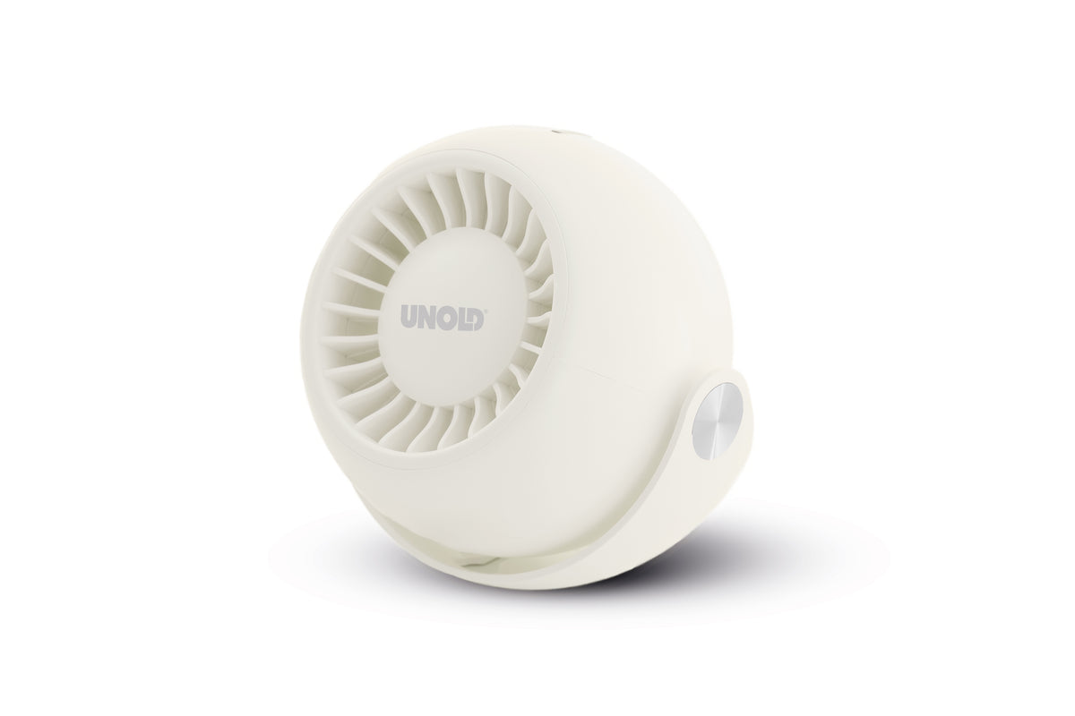 Der Unold Ventilator Breezy Bowl ist ein kompakter, weißer, runder Ventilator mit einem runden Gitter, das leicht zur Seite geneigt und auf einer weißen Oberfläche platziert ist, wo es einen weichen Schatten wirft.