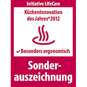 Der ESGE-Zauberstab® M160 G Gourmet von Unold erhielt die rot-weiße Auszeichnung „KüchenInnovation des Jahres 2012“ für besondere Ergonomie, was an der Plakette mit dem dampfenden Teller-Symbol zu erkennen ist.